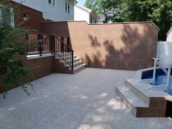 Cour résidentielle avec mur d'intimité en membrane PVC imitation bois et sol granité Innova-Deck Québec